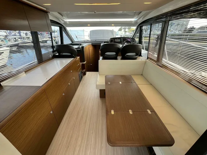 Inventory Clearance Yacht Photos Pics 2023 Bavaria R40 Coupe interior with modern wood finish and seating area.