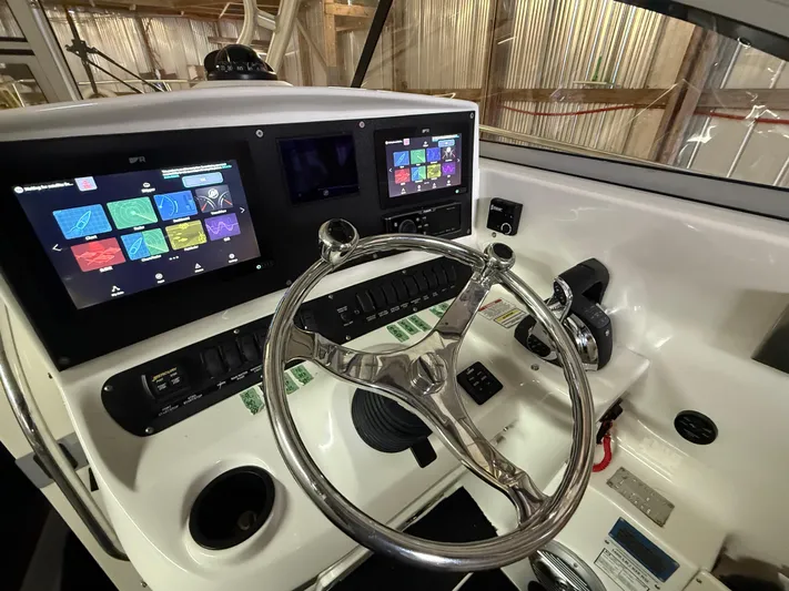  Yacht Photos Pics Helm of 2006 Boston Whaler 305 Conquest with modern navigation displays and controls.