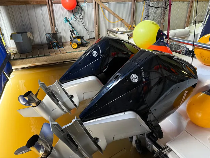  Yacht Photos Pics Twin outboard motors on a 2006 Boston Whaler 305 Conquest in a dock setting.