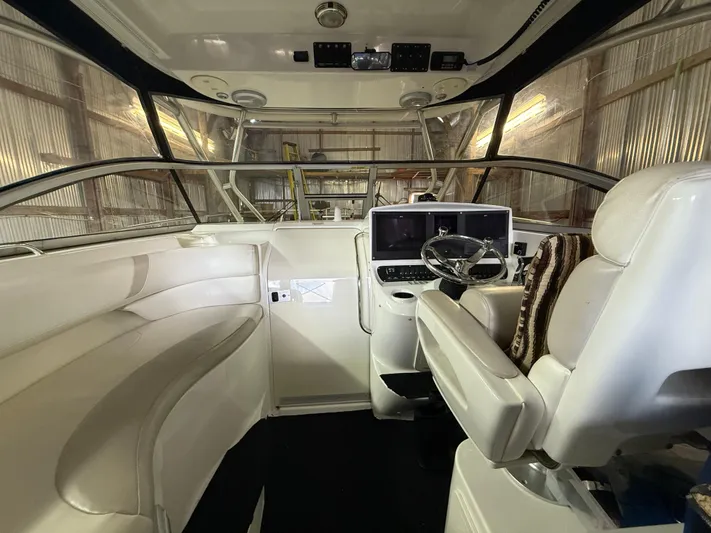  Yacht Photos Pics 2006 Boston Whaler 305 Conquest interior with helm, seating, and navigation equipment.