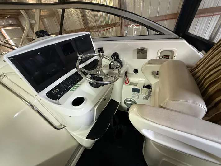  Yacht Photos Pics 2006 Boston Whaler 305 Conquest helm with steering wheel and control panel.