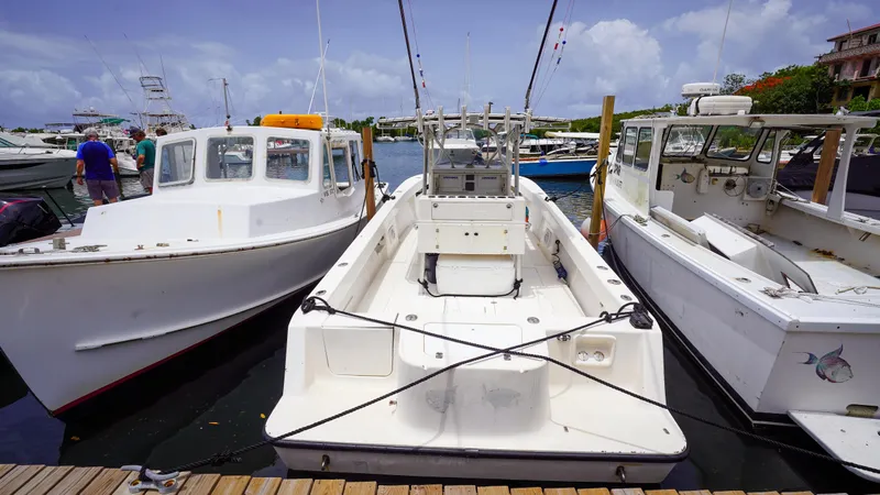  Yacht Photos Pics 2006 SeaVee 34 CC boat docked between two other boats in a marina.