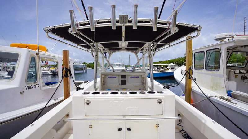  Yacht Photos Pics 2006 SeaVee 34 CC boat docked, featuring a central console and fishing rod holders.