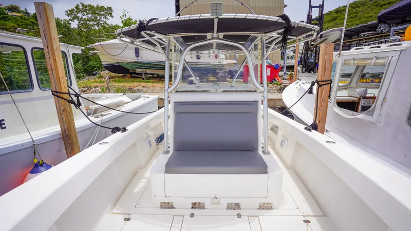  Yacht Photos Pics 2006 SeaVee 34 CC boat interior with seating, docked among other vessels.