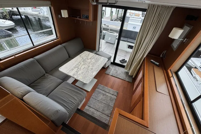 Balena Yacht Photos Pics Interior of 2015 Beneteau Swift Trawler 50 with cozy seating and marble table.