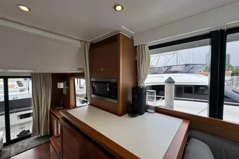 Balena Yacht Photos Pics Interior of 2015 Beneteau Swift Trawler 50 with modern kitchen and marina view.