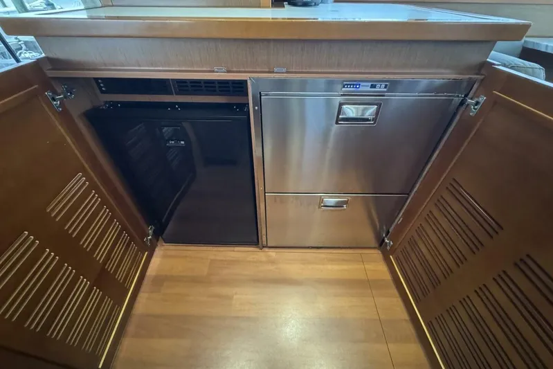 Balena Yacht Photos Pics 2015 Beneteau Swift Trawler 50 kitchen with stainless steel appliances and wooden cabinetry.
