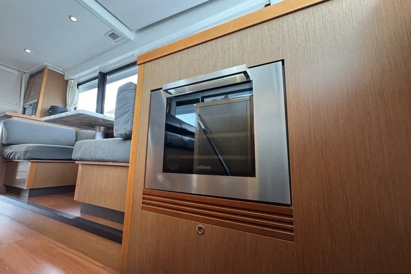 Balena Yacht Photos Pics Interior of 2015 Beneteau Swift Trawler 50, featuring modern seating and built-in oven.