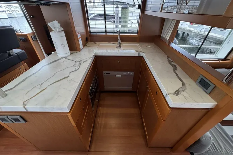 Balena Yacht Photos Pics Luxurious kitchen interior of 2015 Beneteau Swift Trawler 50 with marble countertops.