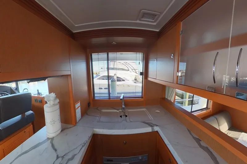 Balena Yacht Photos Pics Interior of 2015 Beneteau Swift Trawler 50 with modern kitchen and marble countertop.