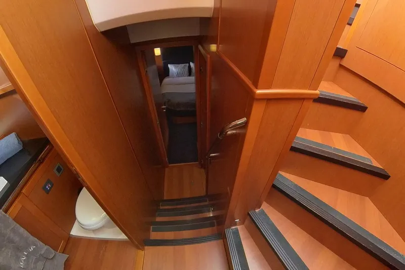 Balena Yacht Photos Pics Interior of 2015 Beneteau Swift Trawler 50, featuring wooden stairs and cozy cabin.