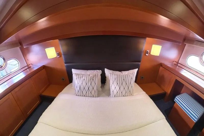 Balena Yacht Photos Pics Luxurious cabin interior of 2015 Beneteau Swift Trawler 50 with elegant wood finish.