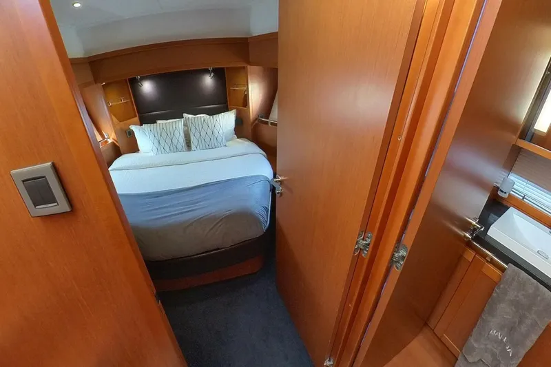 Balena Yacht Photos Pics Luxurious cabin interior of 2015 Beneteau Swift Trawler 50 with cozy bed and ensuite bathroom.