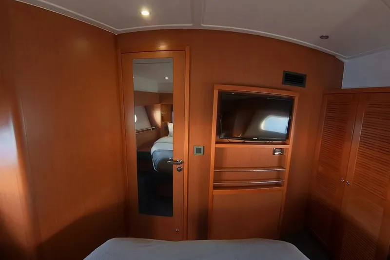 Balena Yacht Photos Pics Interior of 2015 Beneteau Swift Trawler 50 with wood paneling and mounted TV.