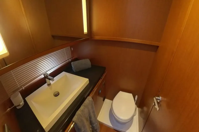 Balena Yacht Photos Pics Luxurious bathroom in 2015 Beneteau Swift Trawler 50 with modern sink and toilet.