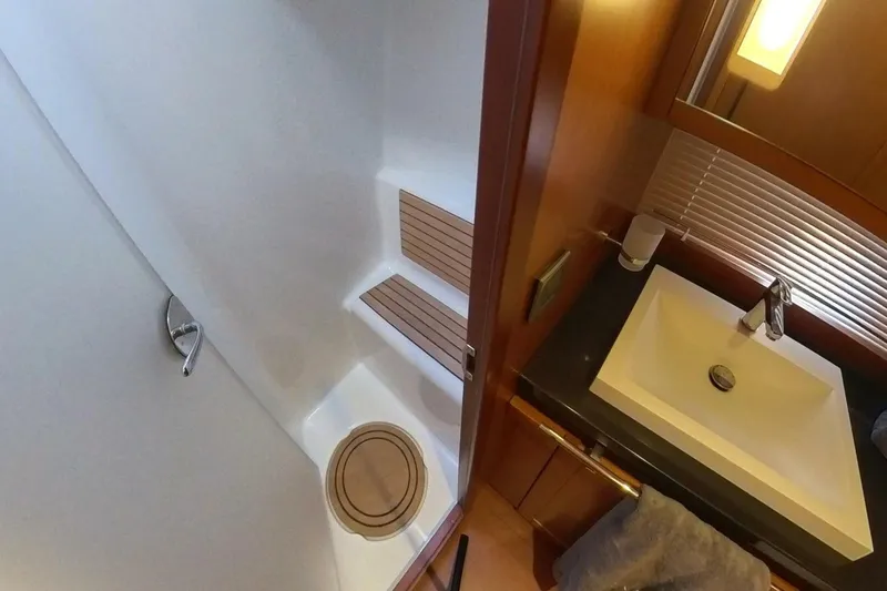 Balena Yacht Photos Pics Bathroom interior of 2015 Beneteau Swift Trawler 50 with sink and shower area.