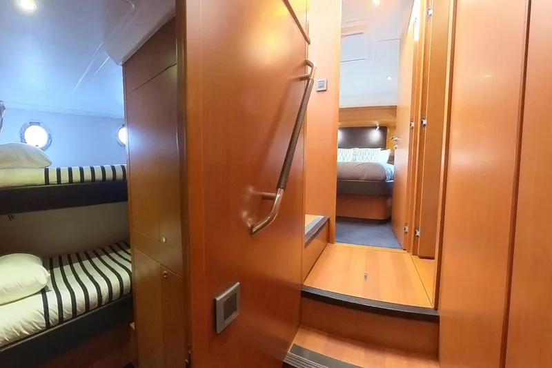 Balena Yacht Photos Pics Interior of 2015 Beneteau Swift Trawler 50, featuring cozy cabin with bunk beds and wood finish.