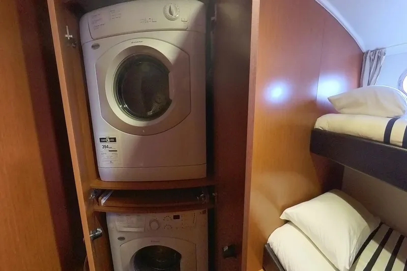 Balena Yacht Photos Pics Laundry area with washer and dryer in 2015 Beneteau Swift Trawler 50 cabin.