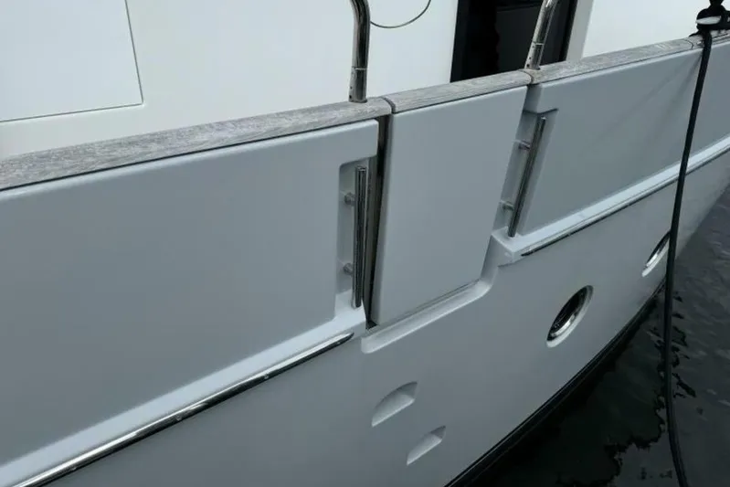 Balena Yacht Photos Pics 2015 Beneteau Swift Trawler 50, side view with railing and portholes.