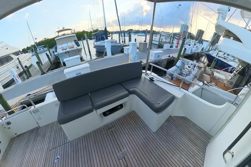 Balena Yacht Photos Pics 2015 Beneteau Swift Trawler 50 at marina, featuring spacious deck seating.