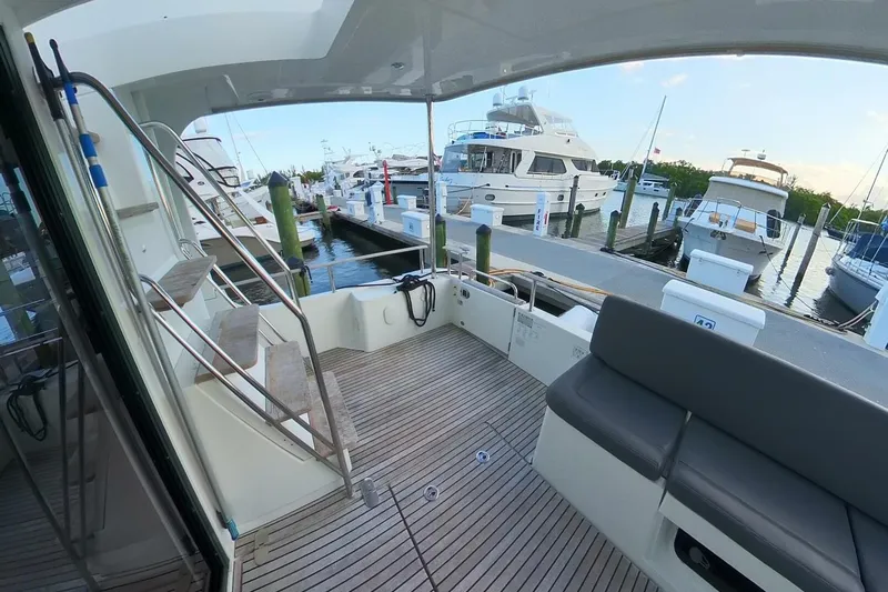 Balena Yacht Photos Pics 2015 Beneteau Swift Trawler 50 docked, featuring spacious deck and marina view.