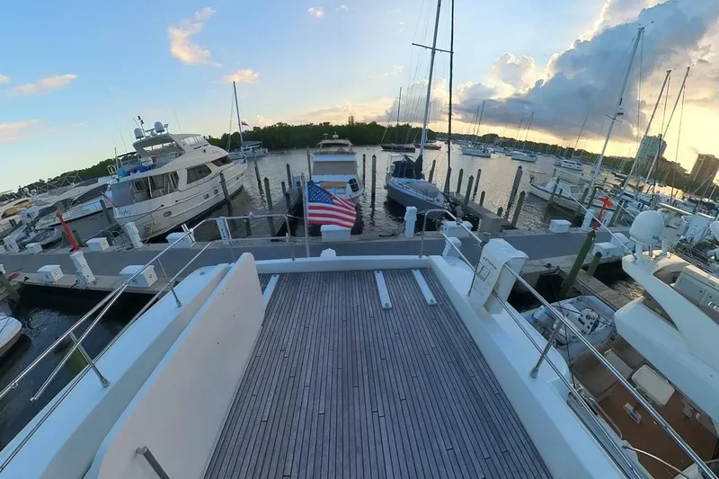 Balena Yacht Photos Pics 2015 Beneteau Swift Trawler 50 docked at marina during sunset, surrounded by boats.