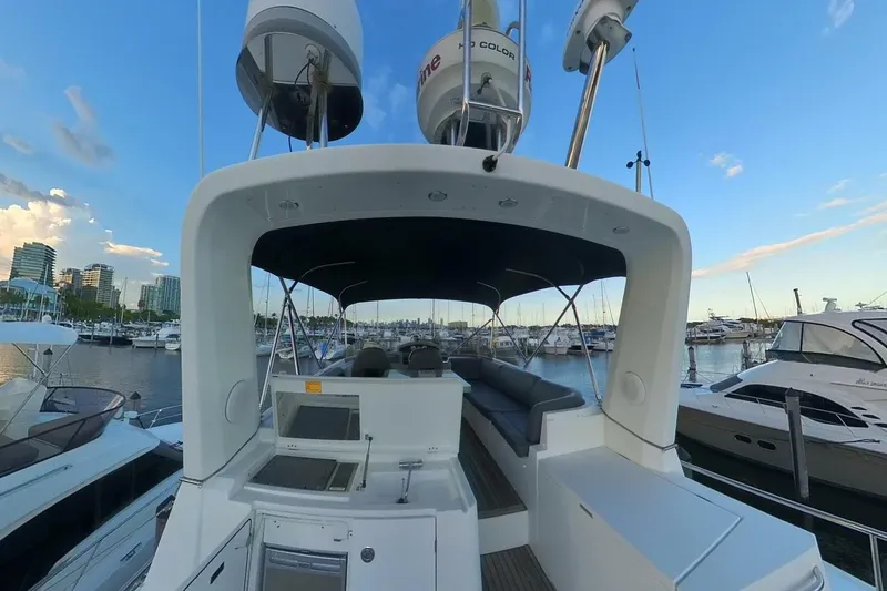 Balena Yacht Photos Pics 2015 Beneteau Swift Trawler 50 at marina, showcasing upper deck and seating area.