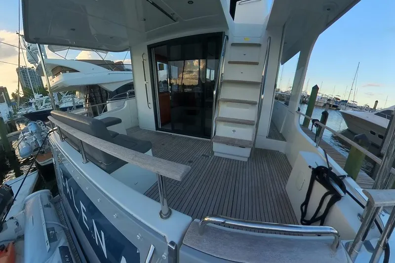 Balena Yacht Photos Pics 2015 Beneteau Swift Trawler 50 docked, showcasing spacious deck and marina view.