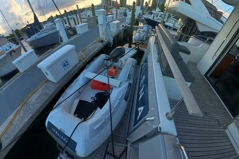 Balena Yacht Photos Pics 2015 Beneteau Swift Trawler 50 docked with inflatable boat, marina view.