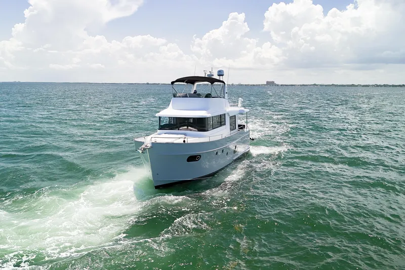 Balena Yacht Photos Pics 2015 Beneteau Swift Trawler 50 cruising on open water under a cloudy sky.