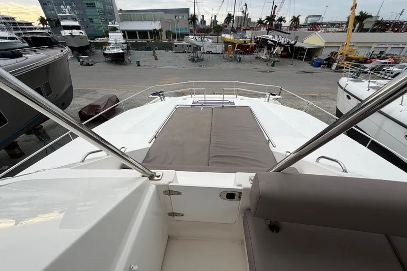  Yacht Photos Pics 2016 Leopard 51 Powercat yacht deck view at marina with surrounding boats.