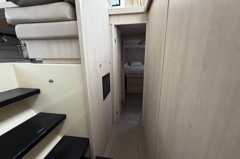  Yacht Photos Pics Interior of 2016 Leopard 51 Powercat yacht, featuring stairs and a cozy cabin hallway.
