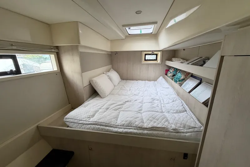 Yacht Photos Pics Cozy bedroom interior of 2016 Leopard 51 Powercat with bed, pillows, and shelves.