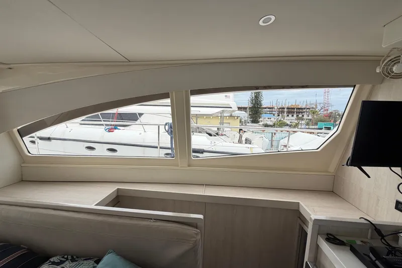  Yacht Photos Pics Interior view of 2016 Leopard 51 Powercat with marina and boats visible through windows.