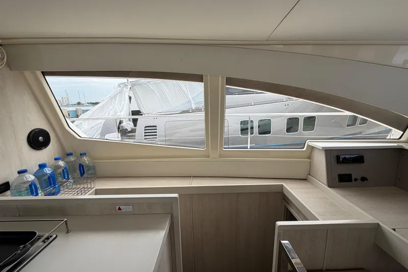  Yacht Photos Pics Interior view of 2016 Leopard 51 Powercat yacht with window and water bottles.