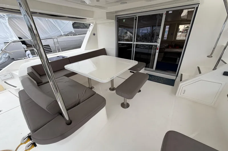  Yacht Photos Pics 2016 Leopard 51 Powercat interior with seating area and table, featuring modern design.
