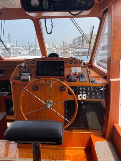 Southerly Yacht Photos Pics Helm of 1990 Lyman-Morse 52 yacht with wooden dashboard and steering wheel.