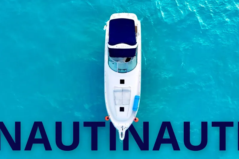 Nauti Nauti Yacht Photos Pics Aerial view of 2000 Searay 460 Sundancer yacht on turquoise water.