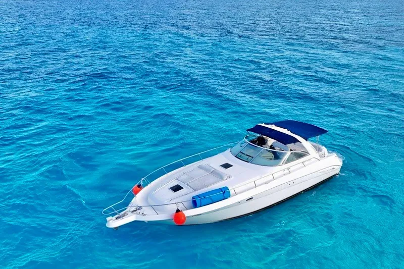 Nauti Nauti Yacht Photos Pics 2000 Searay 460 Sundancer yacht cruising on clear blue ocean waters.