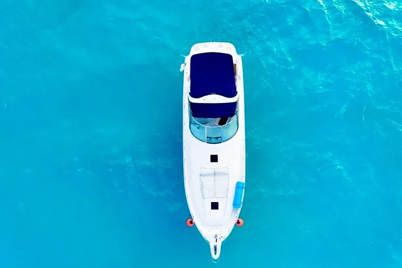 Nauti Nauti Yacht Photos Pics Aerial view of 2000 Searay 460 Sundancer yacht on clear blue water.