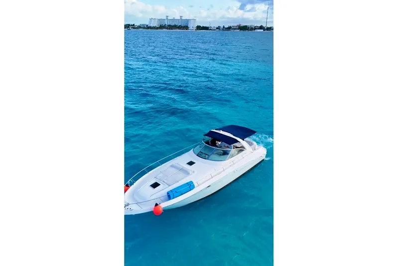 Nauti Nauti Yacht Photos Pics 2000 Searay 460 Sundancer cruising on clear blue ocean waters.