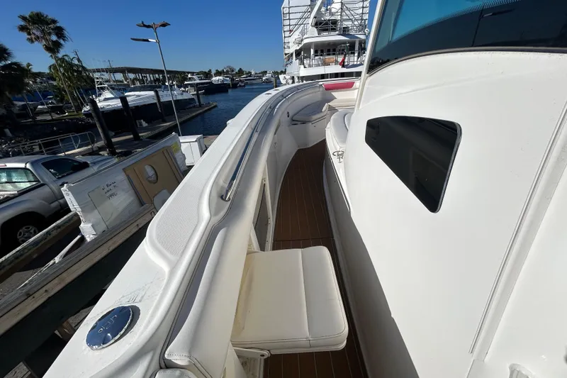 Tt Virtue Yacht Photos Pics 2012 Boston Whaler 370 Outrage boat docked, showcasing sleek design and spacious deck.