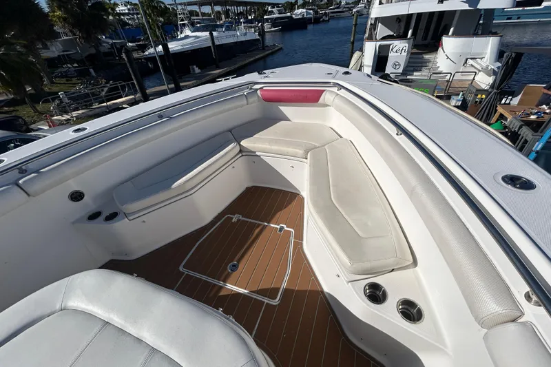 Tt Virtue Yacht Photos Pics 2012 Boston Whaler 370 Outrage boat interior with cushioned seating and wood-style flooring.