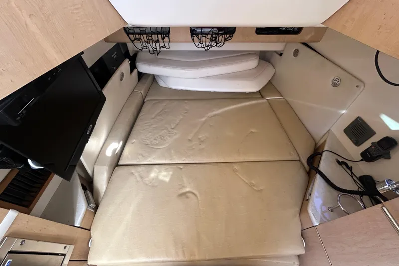 Tt Virtue Yacht Photos Pics 2012 Boston Whaler 370 Outrage cabin interior with beige cushions and modern amenities.