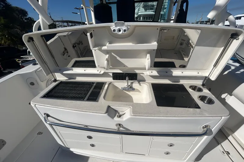 Tt Virtue Yacht Photos Pics 2012 Boston Whaler 370 Outrage boat kitchen with sink, grill, and storage compartments.