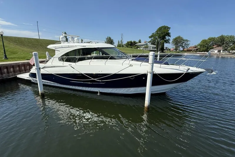  Yacht Photos Pics 2013 Cruisers Yachts Cantius docked in a serene marina setting.