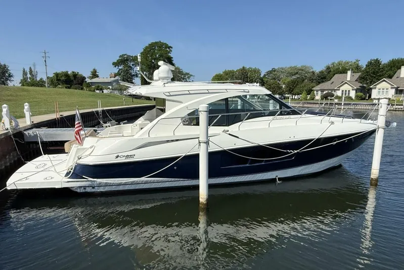  Yacht Photos Pics 2013 Cruisers Yachts Cantius docked in a serene marina setting.