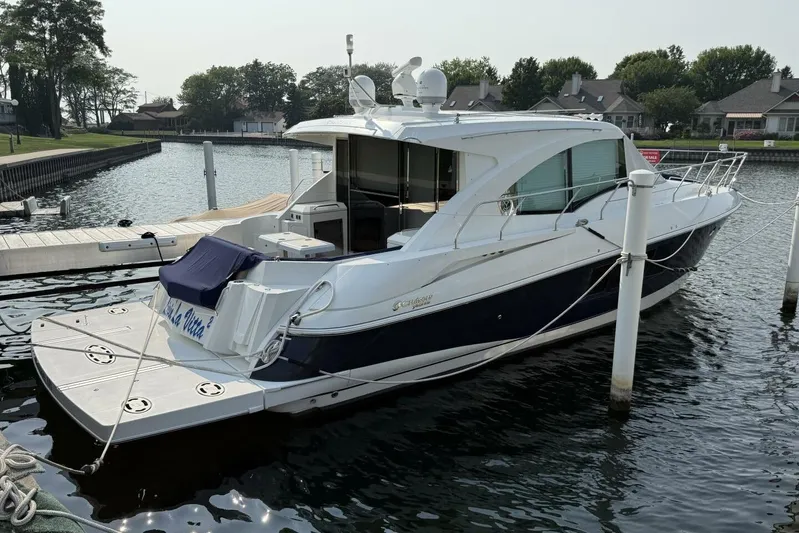  Yacht Photos Pics 2013 Cruisers Yachts Cantius docked in a serene marina setting.