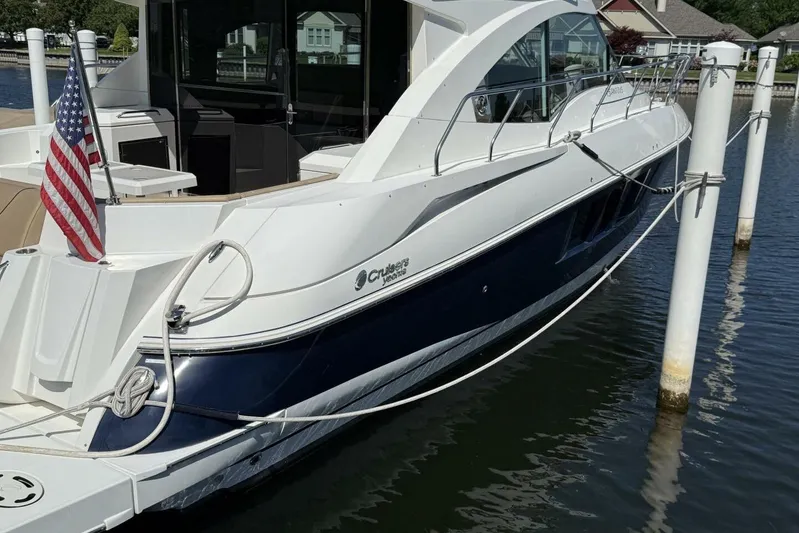  Yacht Photos Pics 2013 Cruisers Yachts Cantius docked, featuring sleek design and American flag.