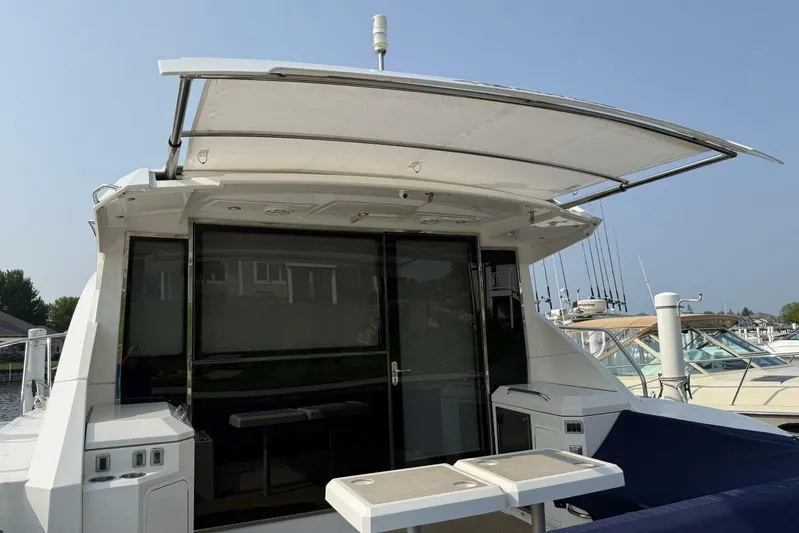  Yacht Photos Pics 2013 Cruisers Yachts Cantius with open deck and modern design in marina setting.